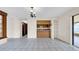 An open-plan living space with a view of the kitchen and backyard entrance at 6915 N Hubert Ave, Tampa, FL 33614