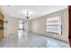 A bright living room with a view of the backyard, kitchen, and an ornate window at 6915 N Hubert Ave, Tampa, FL 33614