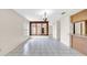 Spacious living room featuring tile floors, natural light from windows, and open access to other rooms at 6915 N Hubert Ave, Tampa, FL 33614
