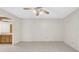 Bright living room featuring tile flooring, ceiling fan, and partial view of the kitchen at 6915 N Hubert Ave, Tampa, FL 33614