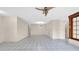 Spacious living room featuring tile floors, neutral walls and natural lighting from a large window at 6915 N Hubert Ave, Tampa, FL 33614