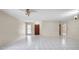 Bright living room features tile flooring, neutral paint, and natural light from the front window at 6915 N Hubert Ave, Tampa, FL 33614