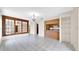 Open-concept living room with tile flooring, large window, and adjacent kitchen area at 6915 N Hubert Ave, Tampa, FL 33614