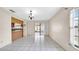 Bright living room with tile flooring, sliding glass doors, and a view of the kitchen at 6915 N Hubert Ave, Tampa, FL 33614