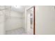 Empty walk-in closet featuring wire shelving and tile floors at 6915 N Hubert Ave, Tampa, FL 33614