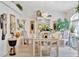 Bright dining room with white table, artistic decor and accessories at 803 Woodcarver Ln, Brandon, FL 33510