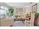 Bright living room with white furniture, light floors, and large windows at 803 Woodcarver Ln, Brandon, FL 33510