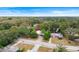 House surrounded by mature trees and landscaping at 810 W River Dr, Temple Terrace, FL 33617