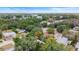 Home is near a lake and is surrounded by mature trees at 810 W River Dr, Temple Terrace, FL 33617