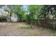 Large backyard is surrounded by a mix of wood and chain-link fencing at 810 W River Dr, Temple Terrace, FL 33617