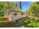 Spacious backyard featuring a well-maintained lawn and the home's exterior with several windows at 810 W River Dr, Temple Terrace, FL 33617