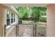 View of backyard with chain link fence and mature trees, visible from screened porch at 810 W River Dr, Temple Terrace, FL 33617