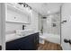 Updated bathroom with sleek fixtures, modern vanity, and stylish tile in shower at 810 W River Dr, Temple Terrace, FL 33617