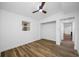 Comfortable bedroom features wood floors, ceiling fan, and closet at 810 W River Dr, Temple Terrace, FL 33617