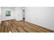 This bedroom features wood-look flooring, closet, a window with natural light and crisp white walls at 810 W River Dr, Temple Terrace, FL 33617