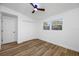 Bedroom with double windows, built-in closet, ceiling fan and wood floors at 810 W River Dr, Temple Terrace, FL 33617