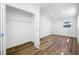 This bedroom features wood-look flooring, a closet with open door, and a window with natural light at 810 W River Dr, Temple Terrace, FL 33617