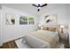 Cozy bedroom with hardwood floors, neutral decor, and a comfortable bed with ample natural light at 810 W River Dr, Temple Terrace, FL 33617