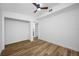 Modern bedroom with wood floors, ceiling fan, and a closet at 810 W River Dr, Temple Terrace, FL 33617