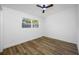 Cozy bedroom with wood floors and natural light from a large window at 810 W River Dr, Temple Terrace, FL 33617