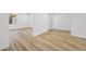 A bedroom is featured with wood flooring, white walls, and ample natural light from a large window at 810 W River Dr, Temple Terrace, FL 33617