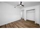 Bedroom features new wood floors and a built-in closet at 810 W River Dr, Temple Terrace, FL 33617