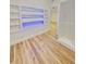 Stylish built-in shelving with accent lighting in a room with wood-look floors at 810 W River Dr, Temple Terrace, FL 33617