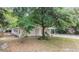 Street view of the home with attached carport at 810 W River Dr, Temple Terrace, FL 33617