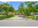 Charming single-story home with a covered carport and mature trees shading the front yard at 810 W River Dr, Temple Terrace, FL 33617