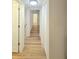 Hallway featuring neutral paint and wood flooring at 810 W River Dr, Temple Terrace, FL 33617