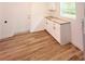 Bright laundry room with utility sink and white cabinets at 810 W River Dr, Temple Terrace, FL 33617