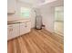 Laundry room with a utility sink, cabinet, and water heater at 810 W River Dr, Temple Terrace, FL 33617