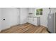 This laundry room features wood-look flooring, butcher block countertop, and natural light at 810 W River Dr, Temple Terrace, FL 33617