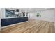 Open living space featuring wood floors and kitchen with stainless steel appliances at 810 W River Dr, Temple Terrace, FL 33617