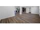 Bright living space showcasing open layout, wood-look flooring, and seamless flow to the kitchen at 810 W River Dr, Temple Terrace, FL 33617
