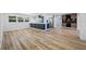 Spacious living room with wood flooring, natural light, and open layout to kitchen at 810 W River Dr, Temple Terrace, FL 33617