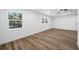 Well-lit living room showcases wood floors and natural light streaming through windows at 810 W River Dr, Temple Terrace, FL 33617