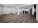 Open-concept living area with wood-look floors, neutral color palette, and view of the modern kitchen at 810 W River Dr, Temple Terrace, FL 33617