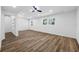 Bright living room featuring wood floors, large windows, and modern ceiling fan at 810 W River Dr, Temple Terrace, FL 33617