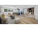 Open-concept living space featuring updated kitchen, bar seating, hardwood floors, and modern finishes at 810 W River Dr, Temple Terrace, FL 33617