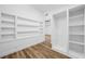 Bedroom with built-in shelving, walk-in closet, and wood floors at 810 W River Dr, Temple Terrace, FL 33617
