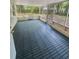 Enclosed sunroom with tile flooring and walls of windows offering natural light at 810 W River Dr, Temple Terrace, FL 33617
