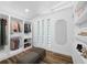 Well-organized walk-in closet with built-in shelving, drawers, and a bench for convenience at 810 W River Dr, Temple Terrace, FL 33617