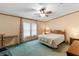 Bright bedroom with a comfy bed, side table, dresser, chair and a well-lit window, creating a relaxing atmosphere at 8270 Oakgren Rd, Brooksville, FL 34601