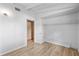 Light filled bedroom with wood look floors, fresh paint, and an open closet at 9221 W Robson St, Tampa, FL 33615