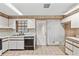 Open concept kitchen with classic appliances, ample counter space, and tile flooring at 9221 W Robson St, Tampa, FL 33615