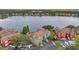 Aerial view of lakeside townhomes showcasing lush green surroundings at 9602 Lake Chase Island Way # 9602, Tampa, FL 33626