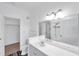 Bathroom with an open closet space, a large vanity mirror, and a toilet at 9602 Lake Chase Island Way # 9602, Tampa, FL 33626