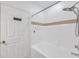 Clean bathroom featuring tiled walls and a bathtub with a shower head at 9602 Lake Chase Island Way # 9602, Tampa, FL 33626