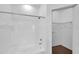 Bathroom showcasing a shower-tub and an adjacent closet with shelving at 9602 Lake Chase Island Way # 9602, Tampa, FL 33626
